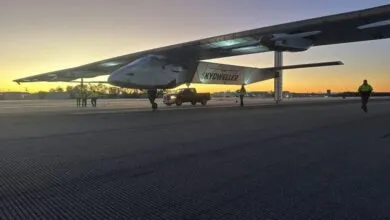 Skydweller aircraft on runway at dawn with ground crew and support truck.