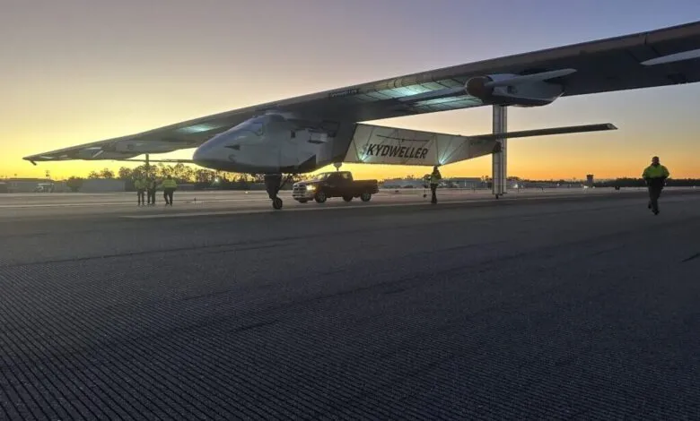 Skydweller aircraft on runway at dawn with ground crew and support truck.