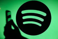 Spotify logo on green screen with phone shadow.