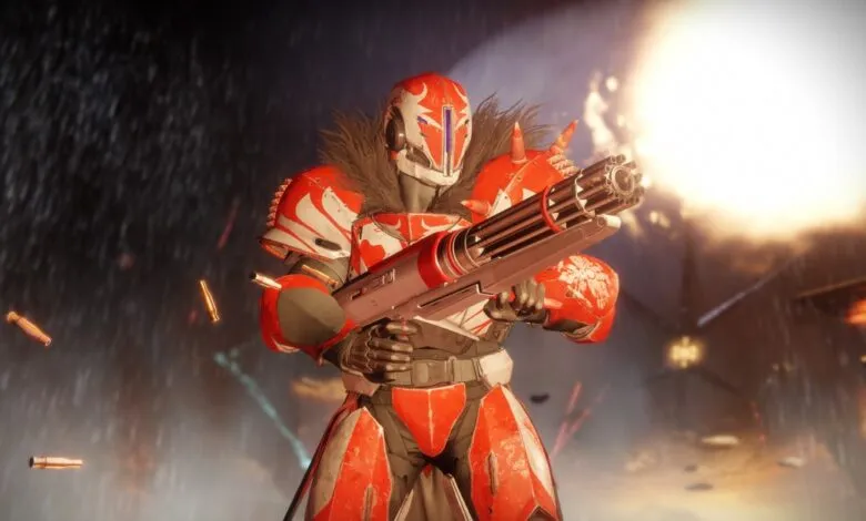 Red and white armored figure holding a large gun in a war-torn environment.