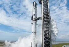 SpaceX Starship on launchpad with water suppression system activated.