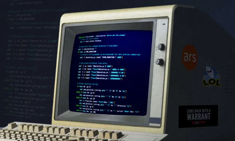 Retro computer displaying code with stickers on the side.