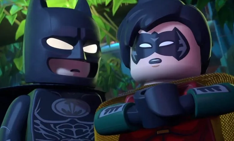 Lego Batman and Robin stand side-by-side, looking serious.