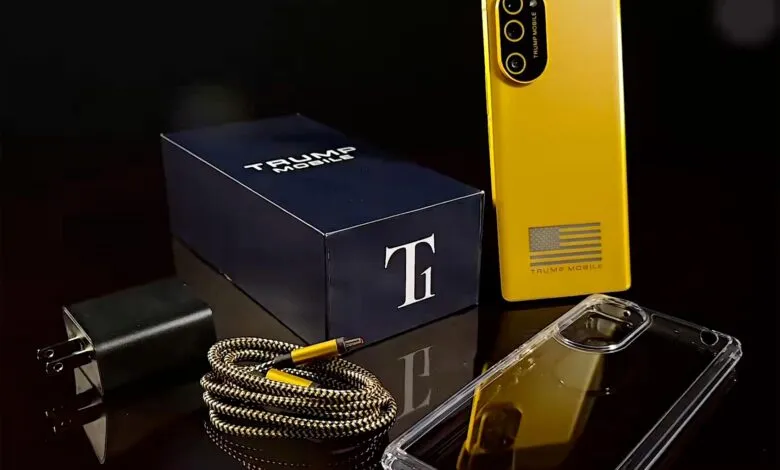 Trump Mobile phone with box, charger, cable, and case on a reflective surface.
