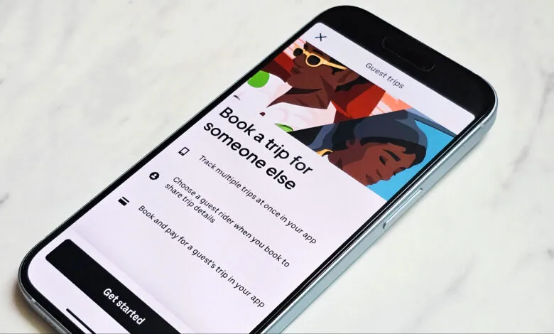 Uber app showing 'Book a trip for someone else' feature on a smartphone.