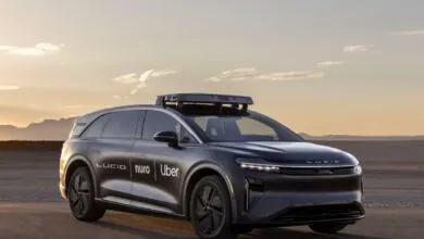 Lucid Air autonomous vehicle with Uber and Nuro logos on the side.