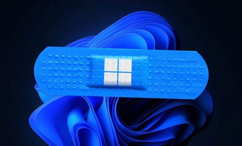 Windows 11 logo covered by a blue band-aid, symbolizing a software patch.