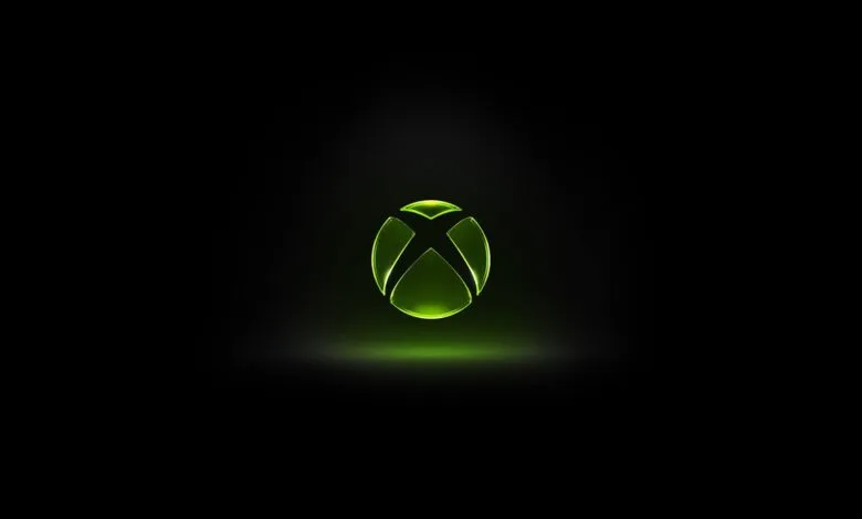 Glowing green Xbox logo on a black background.