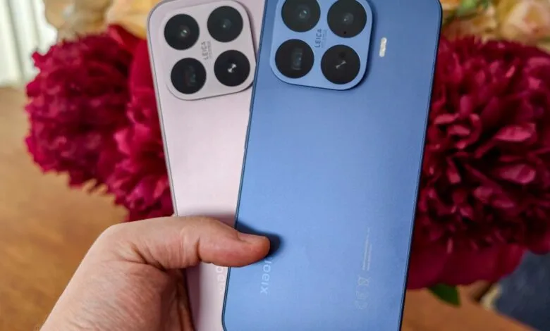 Hand holding pink and blue Xiaomi 14 Pro smartphones with Leica camera.