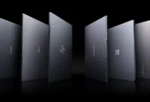 Six sleek laptops from different brands stand upright against a black background.