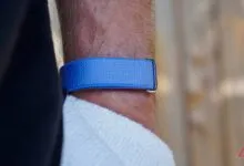 Close-up of blue fabric watch band on a hairy wrist.