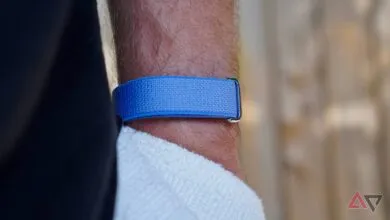 Close-up of blue fabric watch band on a hairy wrist.