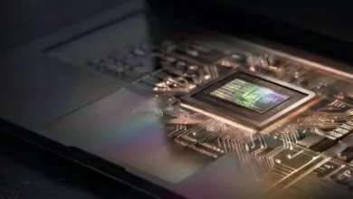 Close-up of a computer chip on a circuit board, showing intricate details.