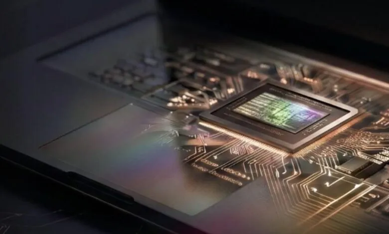 Close-up of a computer chip on a circuit board, showing intricate details.
