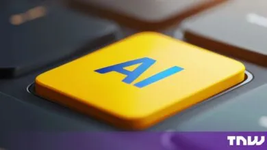 Close-up of a bright yellow keyboard key featuring the blue letters AI, surrounded by dark keys.