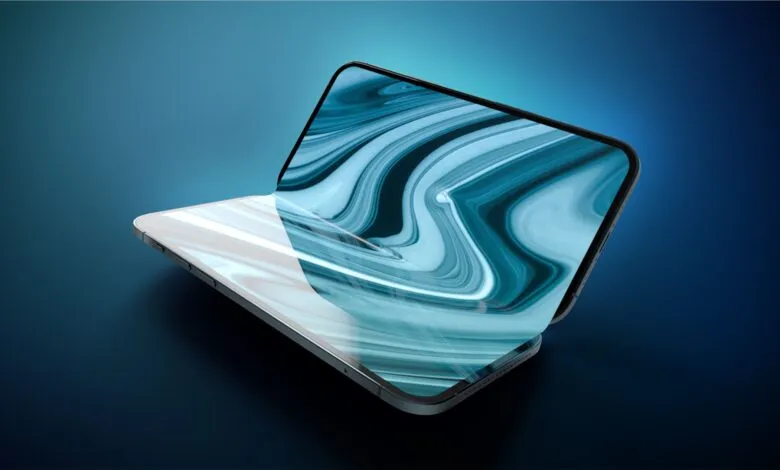 Conceptual foldable smartphone resting open on a dark blue gradient surface with abstract blue wallpaper.