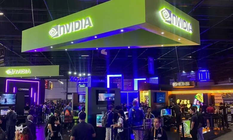 Large NVIDIA booth glowing in vibrant green and blue lights at a bustling gaming convention event.