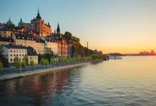 Scenic view of Stockholm waterfront and historic architecture at sunset.