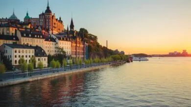 Scenic view of Stockholm waterfront and historic architecture at sunset.