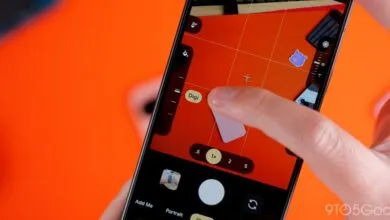 Close-up of a smartphone displaying the Pixel camera interface with red background