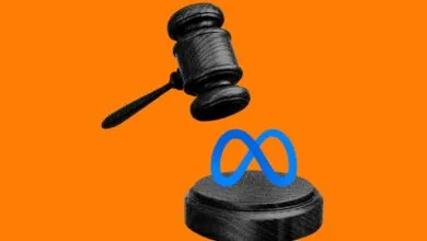 A black wooden gavel hovering over a blue Meta logo resting on a sound block against an orange background.
