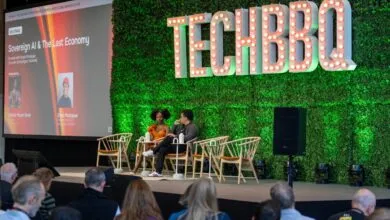 Dominic Madori Davis and Emad Mostaque speaking on stage at the TechBBQ conference.