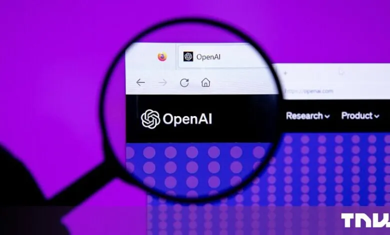 Magnifying glass focused on the OpenAI website on a computer screen against purple background
