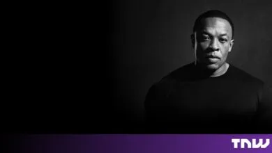 Black and white portrait of music producer and rapper Dr. Dre against a dark background