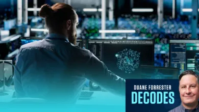 Duane Forrester analyzes complex data on multiple computer monitors in a server room.