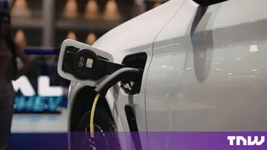 Close-up of a white electric vehicle plugged into a charging station