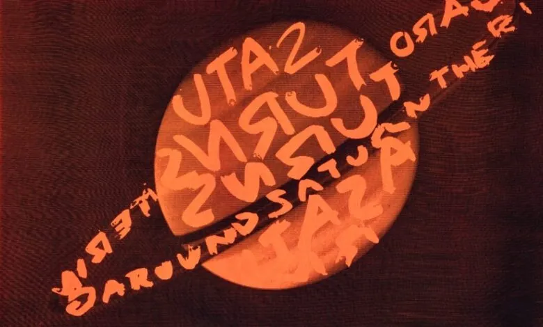 Red tinted screen with large round circle and backwards text across it