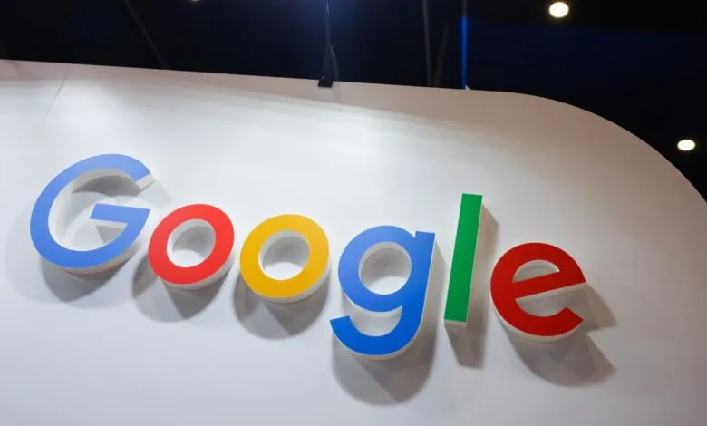 Colorful 3D Google logo mounted on a clean white display wall at a technology event.