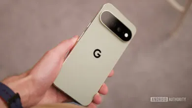 A person holding a light green Google Pixel smartphone, showcasing its back panel and camera bar.