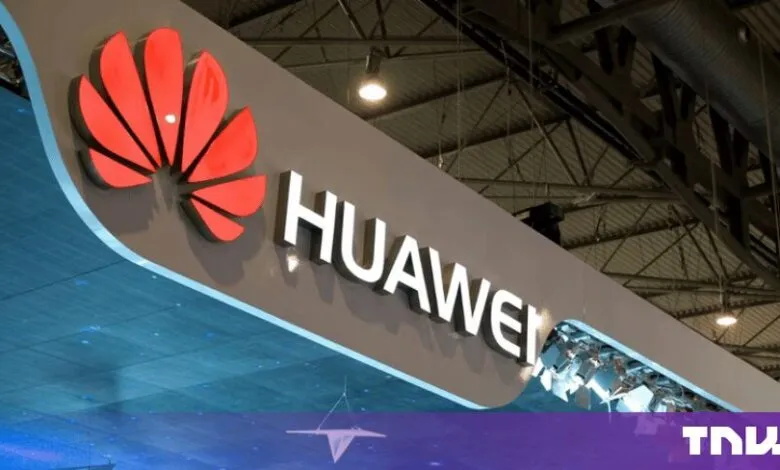 Huawei logo featuring the iconic red flower symbol and white lettering displayed prominently at a tech exhibition.