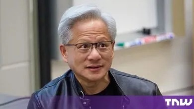 NVIDIA CEO Jensen Huang wearing glasses and a black leather jacket indoors