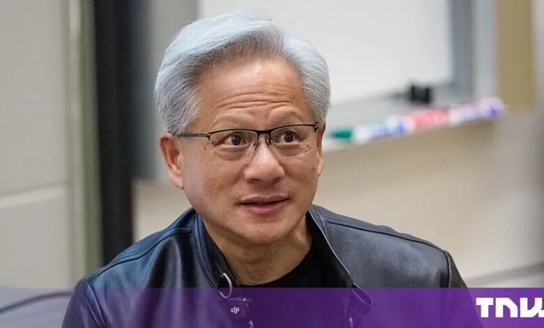 NVIDIA CEO Jensen Huang wearing glasses and a black leather jacket indoors