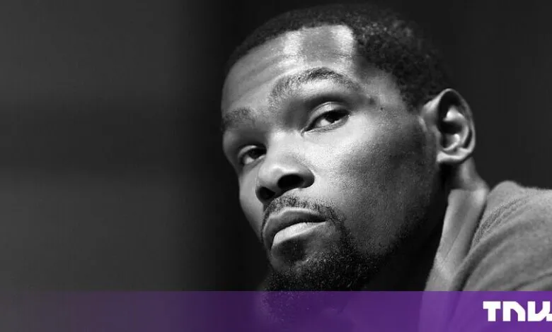 Close-up black and white portrait of NBA basketball player Kevin Durant looking thoughtfully.
