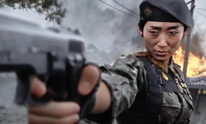A female soldier in military uniform aims a pistol forward in a war zone.
