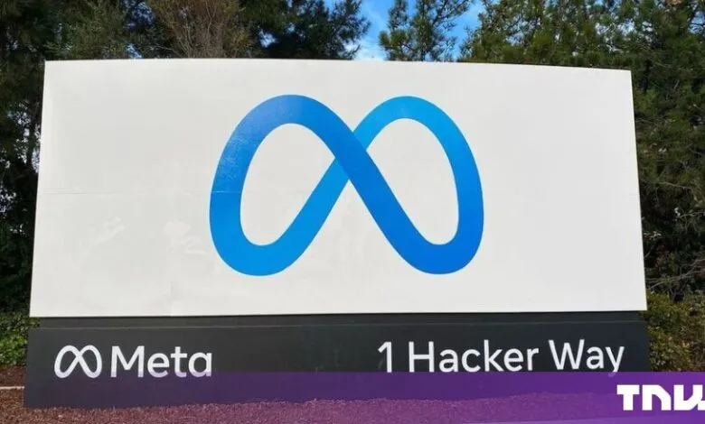 Large Meta corporate sign displaying the blue infinity logo and 1 Hacker Way address.