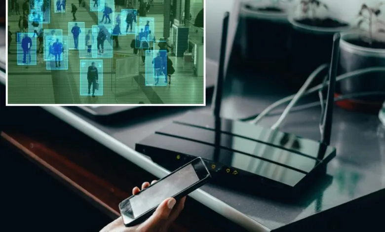 A person holds a smartphone near a wireless router with an overlaid facial recognition screen.