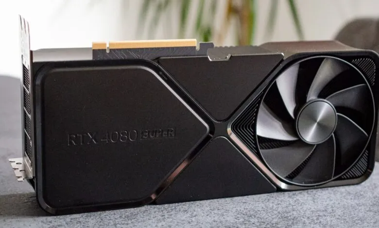 Close-up view of a sleek black Nvidia RTX 4080 Super graphics card resting on a dark surface.
