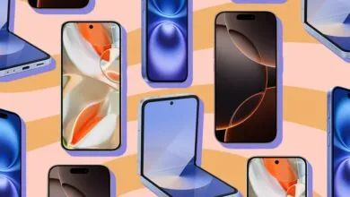 A flatlay collection of modern smartphones showcasing various screens against a peach background