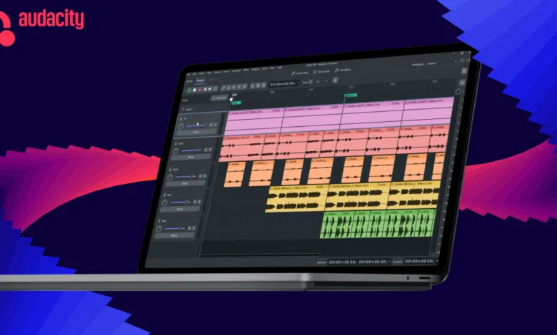 Laptop displaying Audacity audio editing software against a blue and pink abstract background