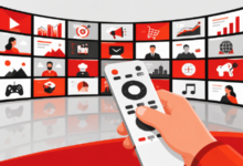 A hand holding a white remote control pointing at a curved screen displaying various digital content tiles.
