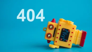 A fallen yellow toy robot lying next to a large white 404 error text against a blue background.