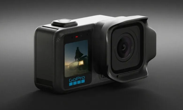 Close-up of a black GoPro action camera with a prominent lens hood against a dark background.