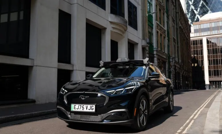 Black autonomous Ford Mustang Mach-E parked on a narrow London street with sensors on the roof.