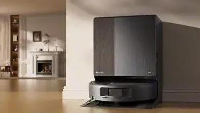 Roomba robot vacuum docked in its charging station inside a modern living room