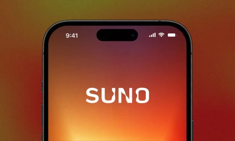Close-up of a smartphone display showing the Suno logo on a warm gradient background.