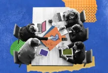 Overhead view of five people collaborating around a wooden meeting table with charts and laptops.